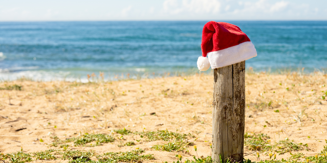 Santa hat on a pole on the beach  Quit Hero