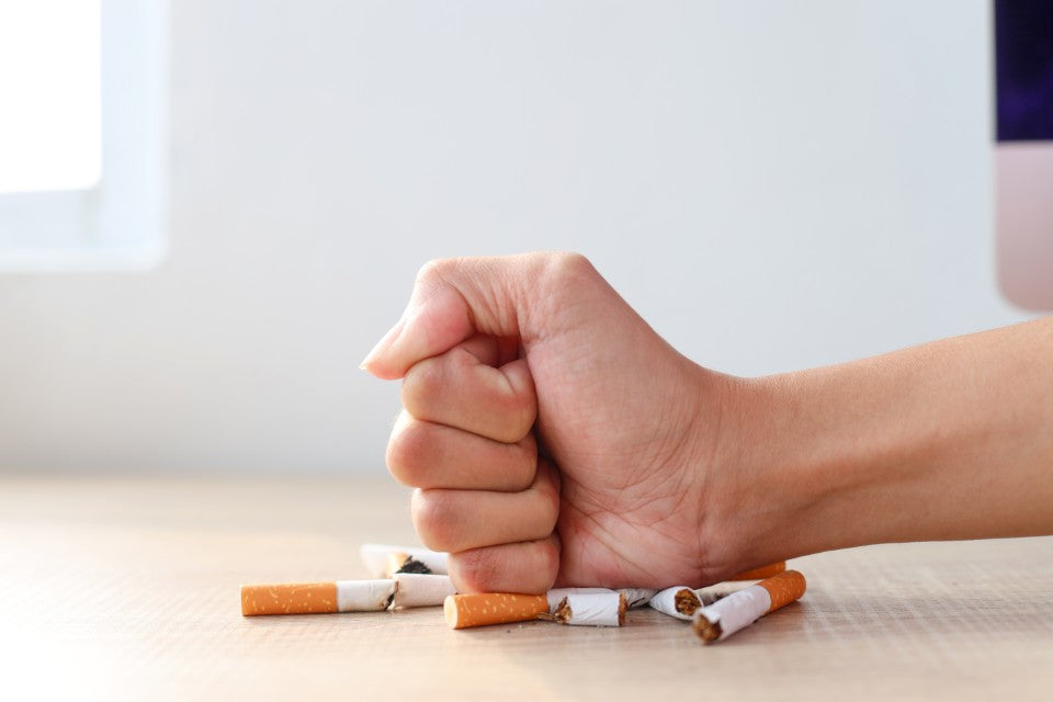 hand crushing cigarettes Quit Hero